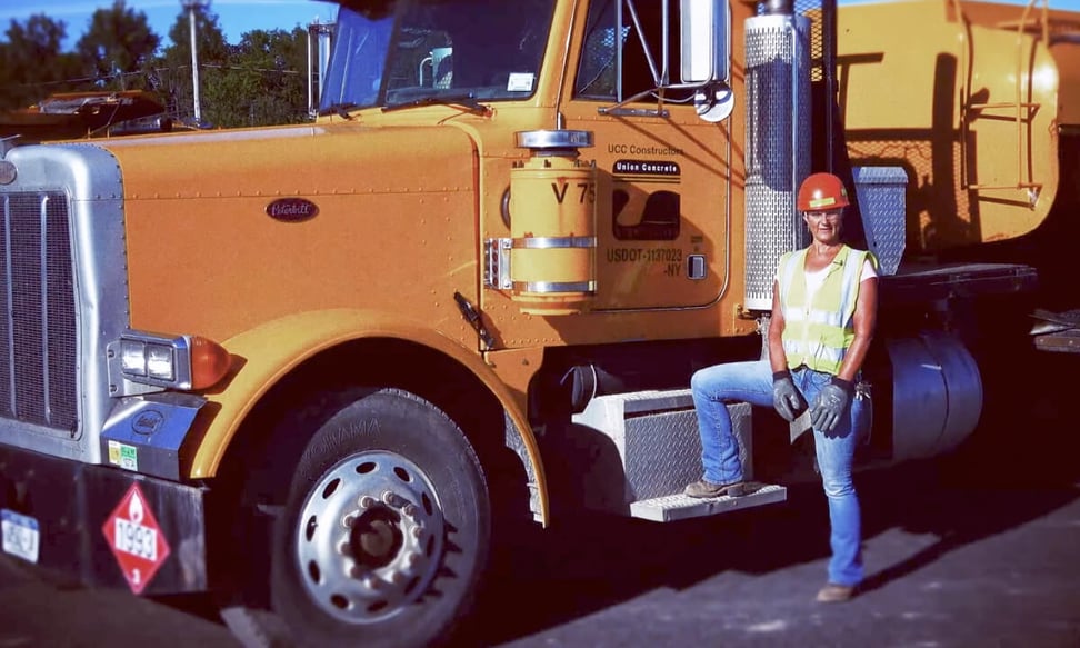 woman stepping in a big construction truck