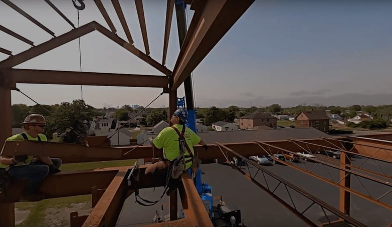 two workers building the roof