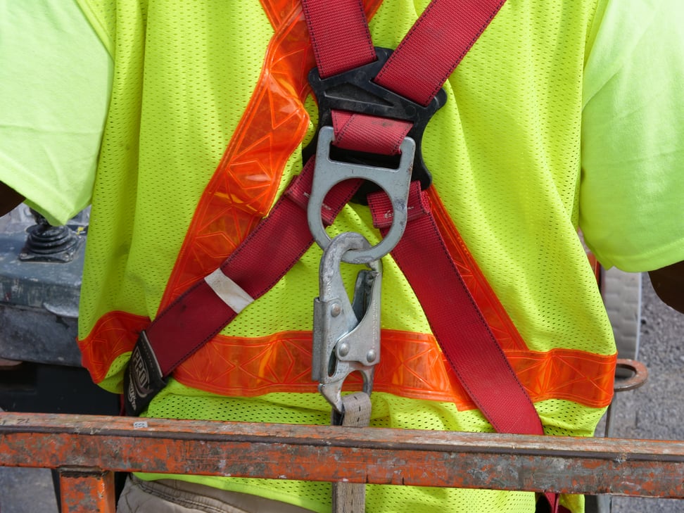 CAHill Tech. Individual wearing a harness for fall safety.